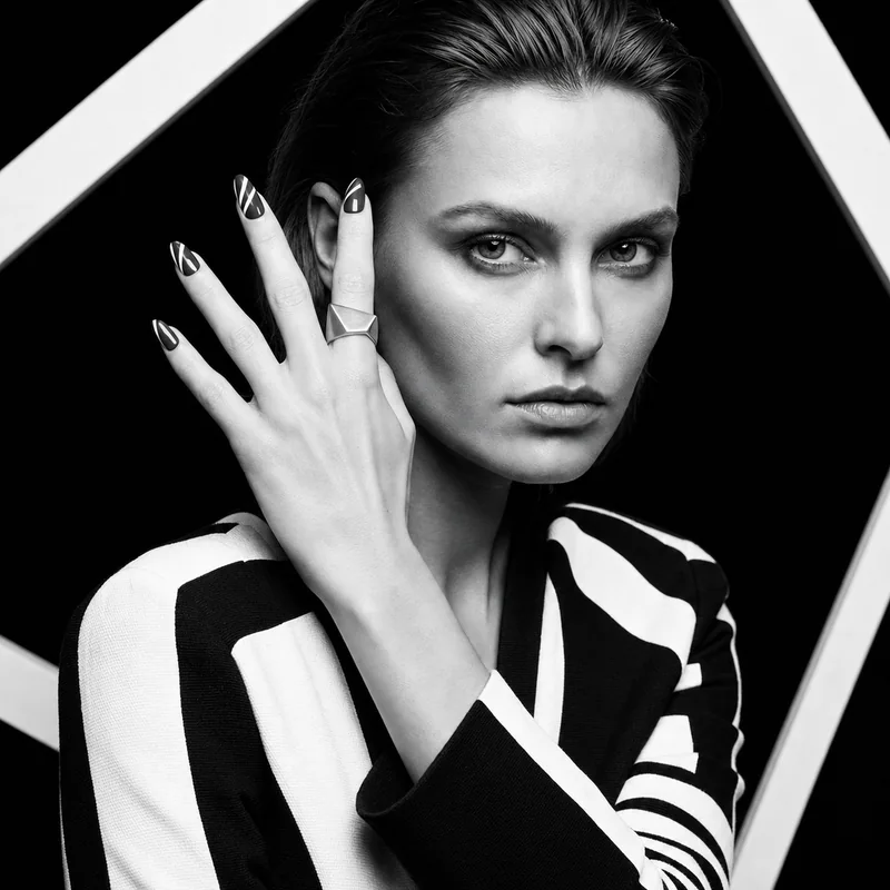 Folded Plane design shown on a hand in a black-and-white portrait